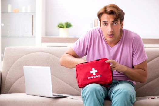 Sick man at home with first aid kit