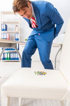 Office prank with sharp thumbtacks on chair