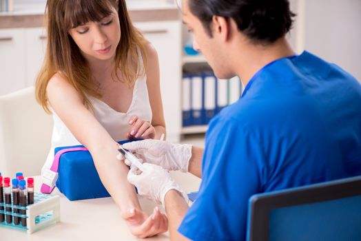 Young patient during blood test sampling procedure  