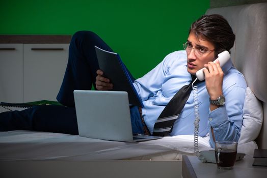 Young businessman under stress in the bedroom at night 