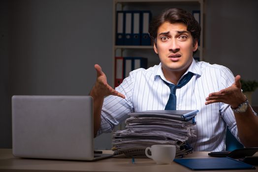 Young financial manager working late at night in office 