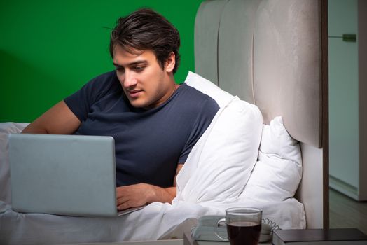 Young handsome man suffering from insomnia at home