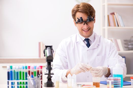 Chemist in the lab checking with ph strips