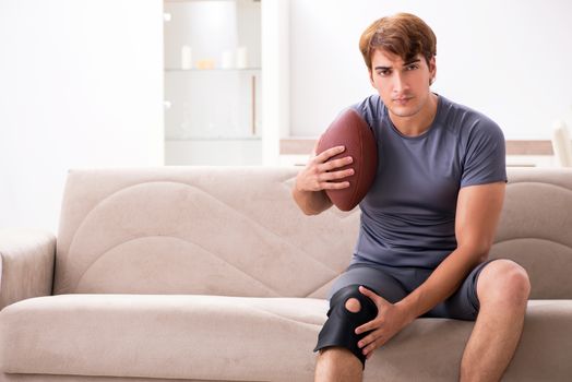 Injured man recovering at home from sports injury