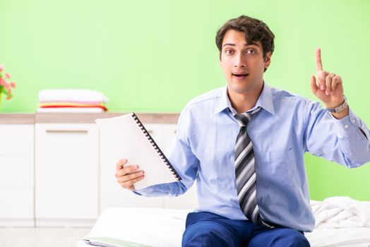 Businessman working overtime in hotel room