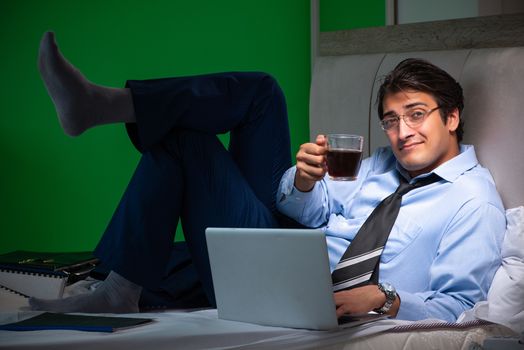 Young businessman under stress in the bedroom at night 