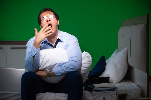 Young businessman under stress in the bedroom at night 