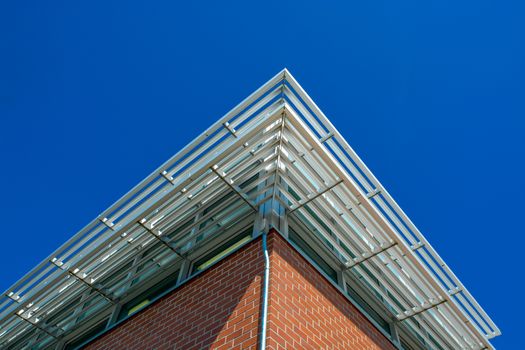 Corner of a building roof with shadowing grid above the windows