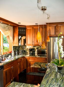 Stylish kitchen wooden interior with ceramic stove on island table