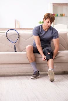 Injured man recovering at home from sports injury