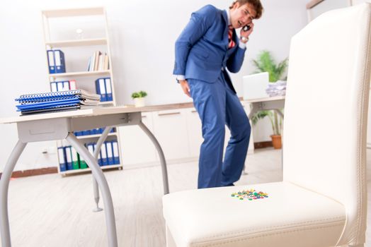 Office prank with sharp thumbtacks on chair