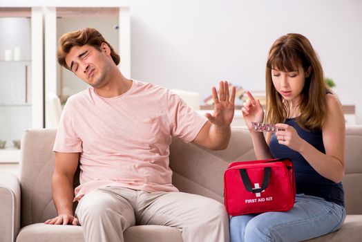 Young family getting treatment with first aid kit