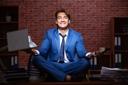 Young businessman working in the office at night 