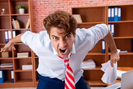 Unhappy businessman sitting in the office 