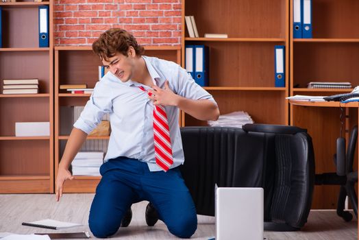Unhappy businessman sitting in the office 