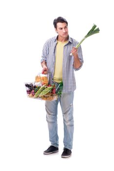 Young man with his grocery shopping on white
