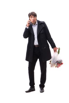 Young handsome man with vegatables in shopping concept 