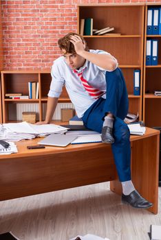 Unhappy businessman sitting in the office 