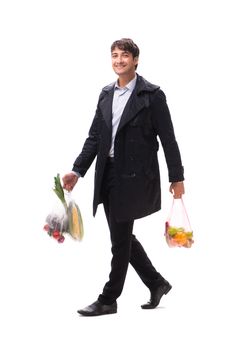 Young handsome man with vegatables in shopping concept 