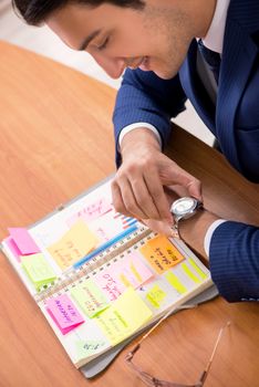 Young handsome employee planning his work activity 