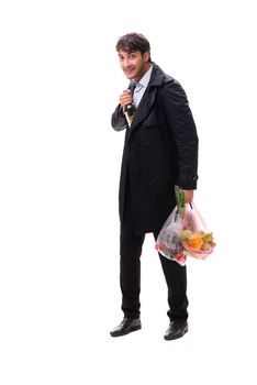 Young handsome man with vegatables in shopping concept 