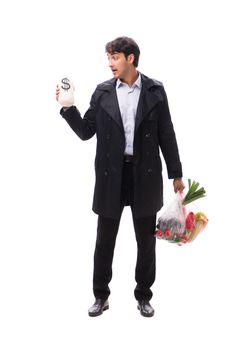 Young handsome man with vegatables in shopping concept 