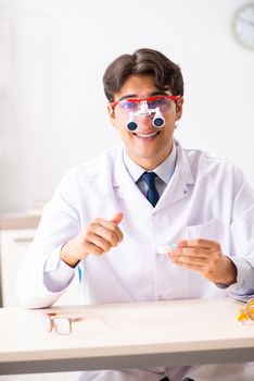 Young handsome doctor oculist working at the clinic 
