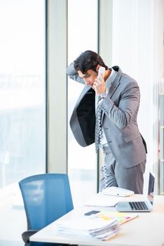 Young successful businessman working at the office 