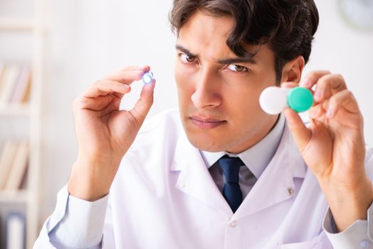 Young handsome doctor oculist working at the clinic 