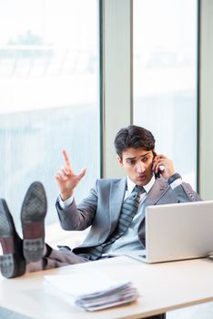 Young successful businessman working at the office 