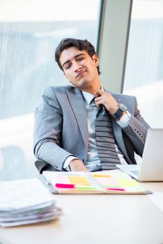Young successful businessman working at the office 