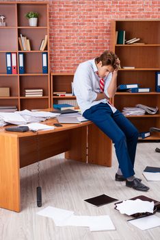 Unhappy businessman sitting in the office 