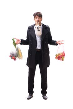 Young handsome man with vegatables in shopping concept 