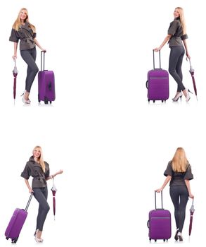 Young beautiful woman with suitcase and umbrella isolated on white 