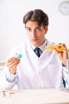 Young handsome doctor oculist working at the clinic 