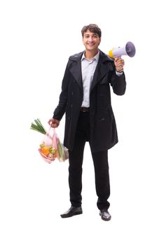 Young handsome man with vegatables in shopping concept 