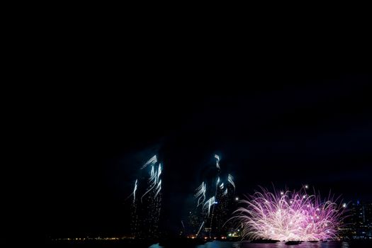 Fireworks on the sea with colorful at night.