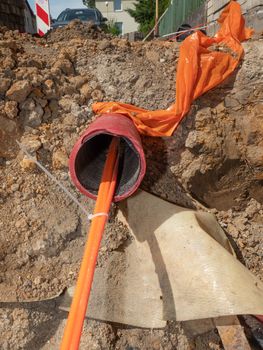 Plastic pipes containing electric cables in the ground. 