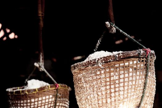 Salt basket hanging on fireplace at home in the countryside.