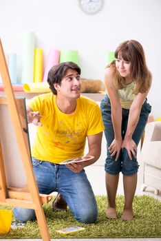 Young couple enjoying painting at home