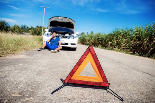 Emergency signs on road in the countryside with blue sky.