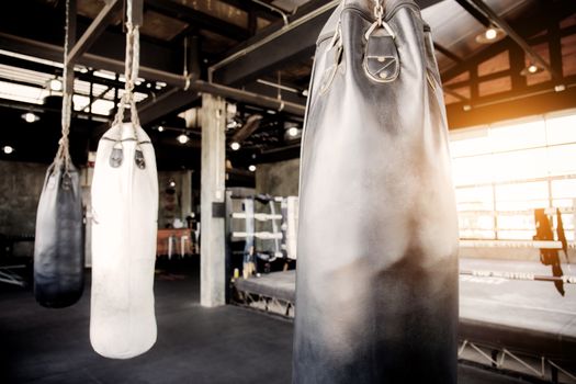 Punching bag hanging in the Thai boxing stadium at sunlight.