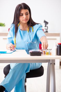 Young beautiful female doctor working in the clinic 