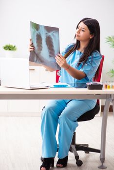 Young beautiful female doctor working in the clinic 