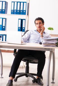 Young employee sitting at the office 