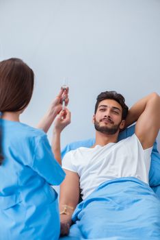 Woman doctor examining male patient in hospital