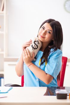 Young beautiful female doctor working in the clinic 