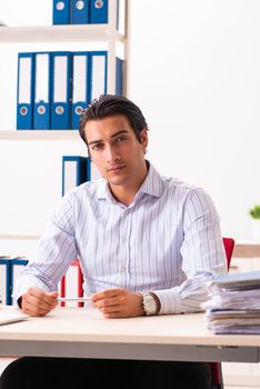 Young employee sitting at the office 