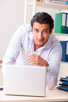 Young employee sitting at the office 