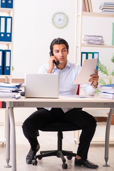 Young employee sitting at the office 